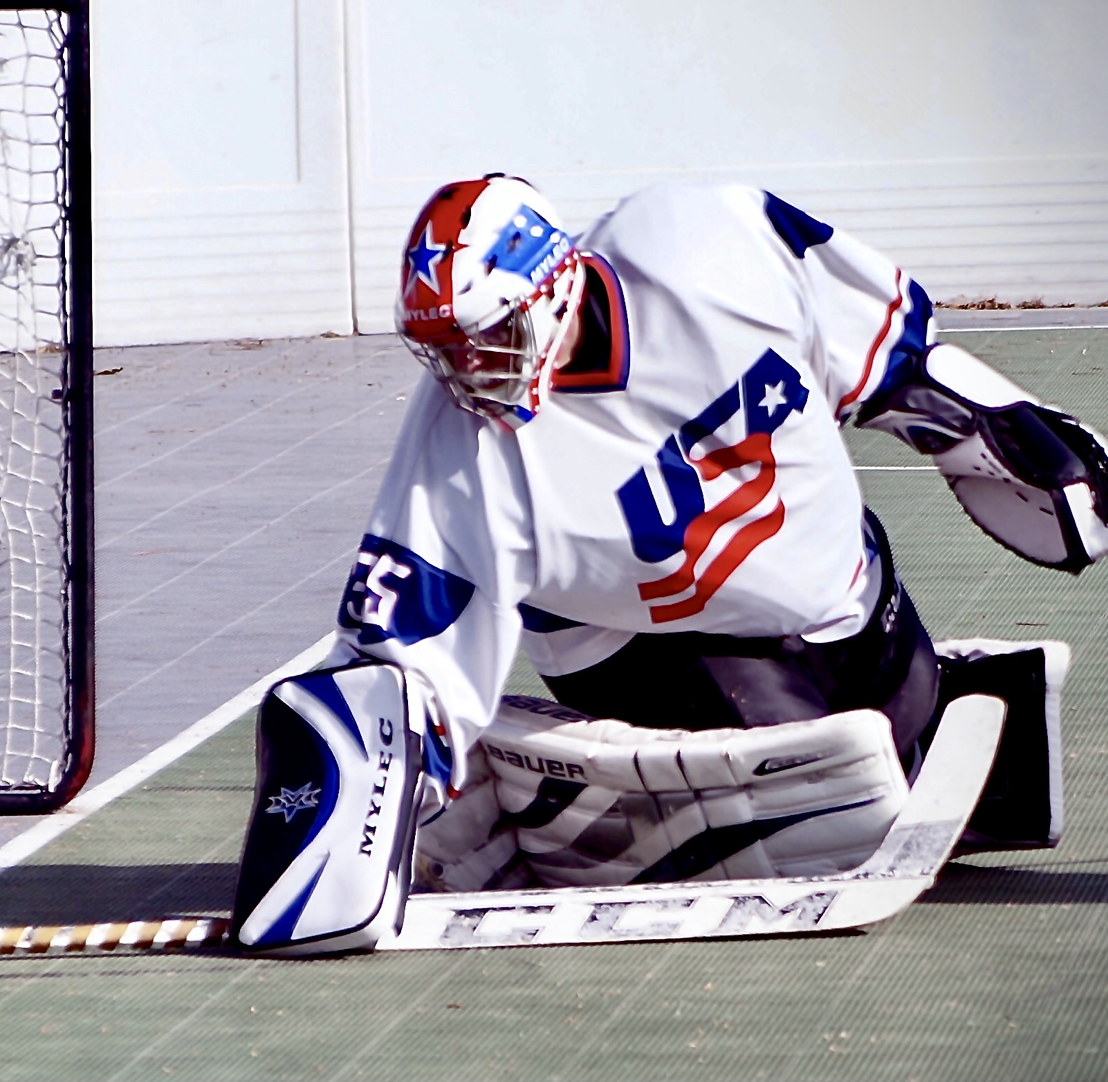 Hockey goalie in action near the net.